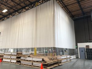 Clear Vinyl Curtains are customized with Opaque Steel Scrim Vinyl for Warehouse Separation